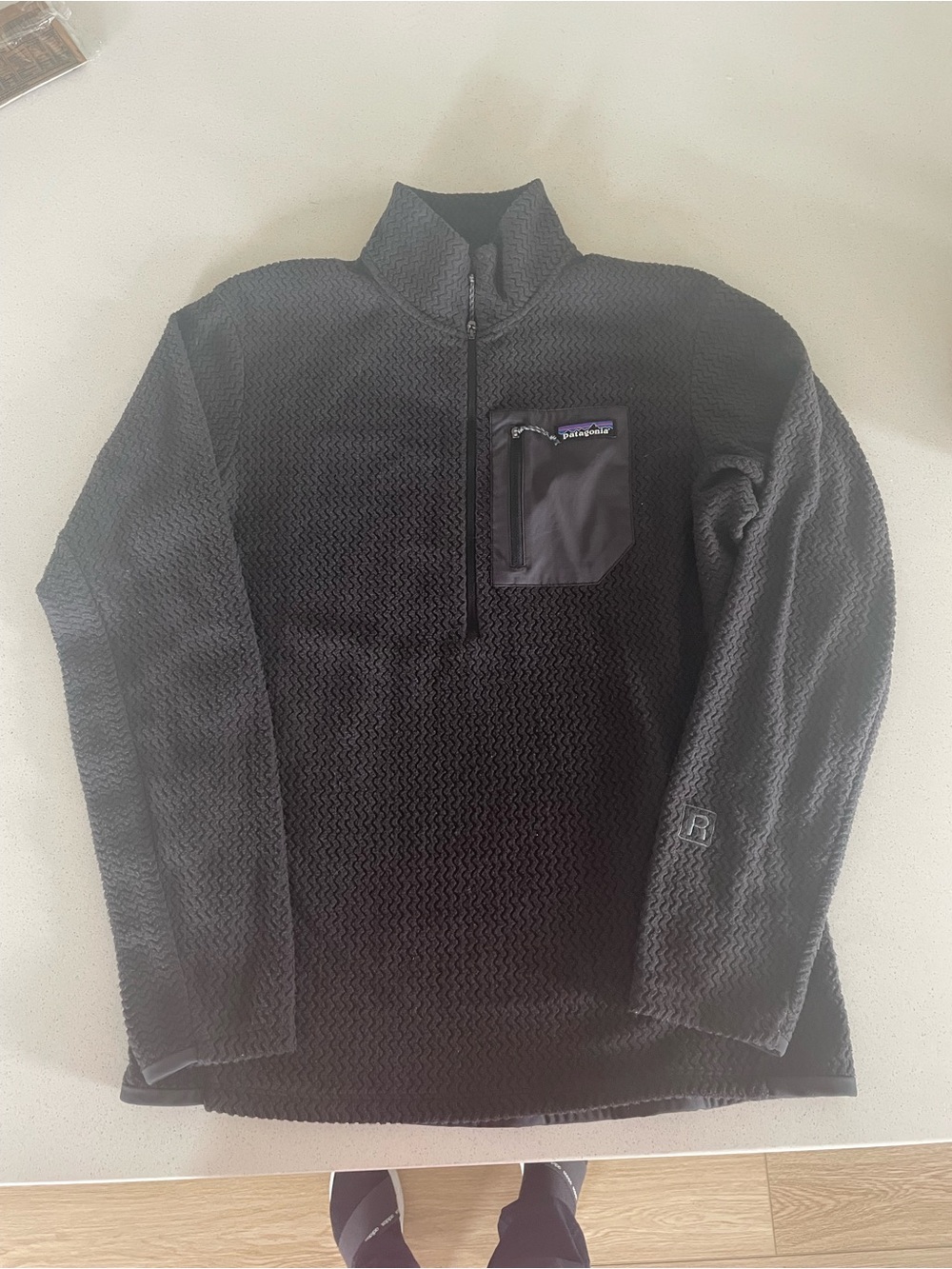 Patagonia Black 1/4 zip . Chest Pocket Panel with Logo. Lightweight .